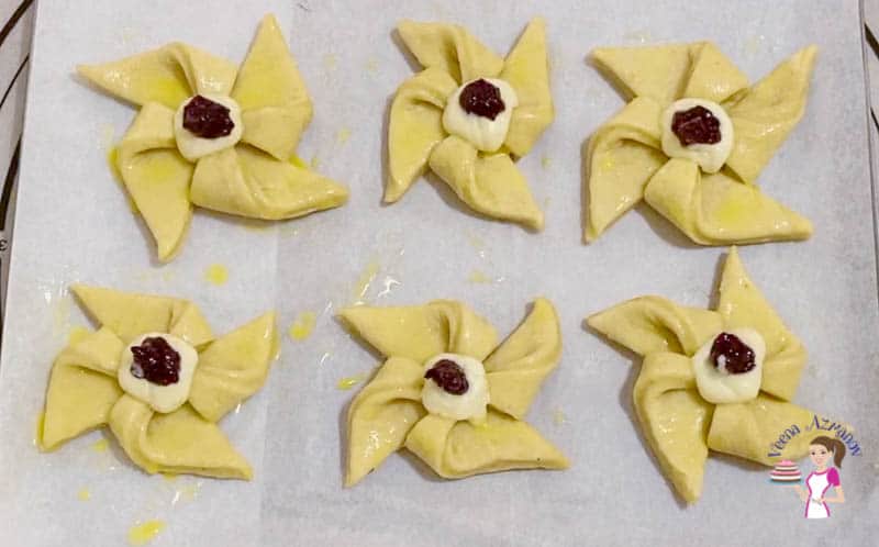 Top each danish pinwheel with cream cheese and jam