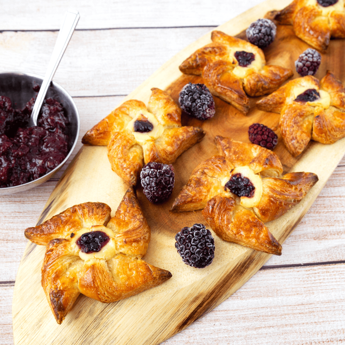 Pinwheel Danishes on a wooden board.