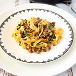 A ground beef pasta with enchilada sauce.