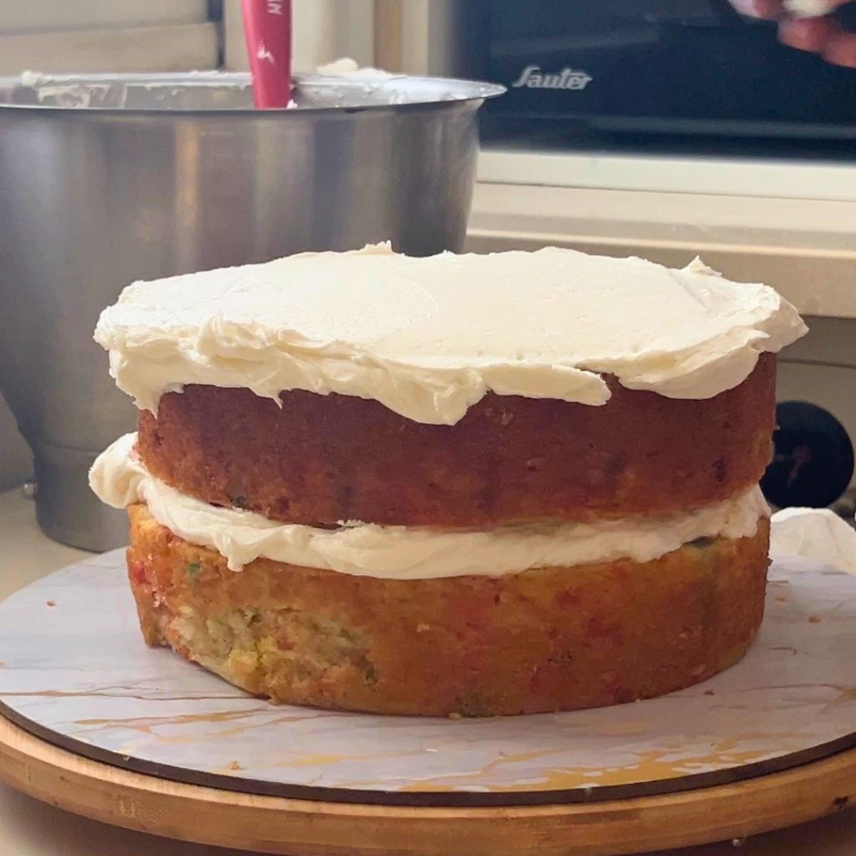 Stacking a funfetti cake.