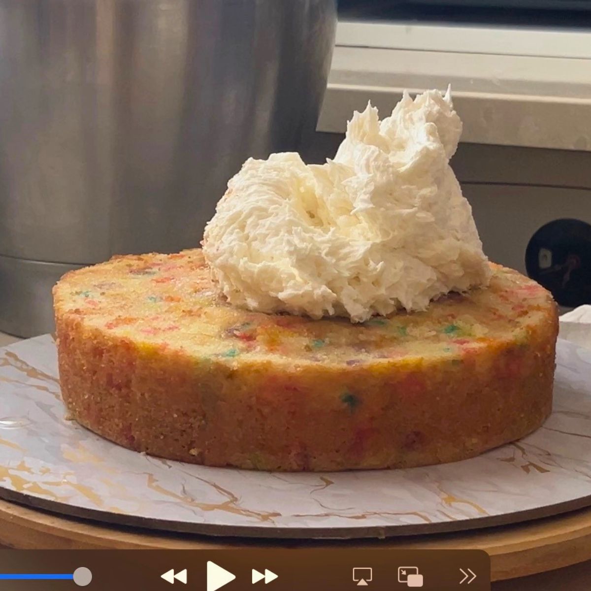 Frosting a funfetti cake.