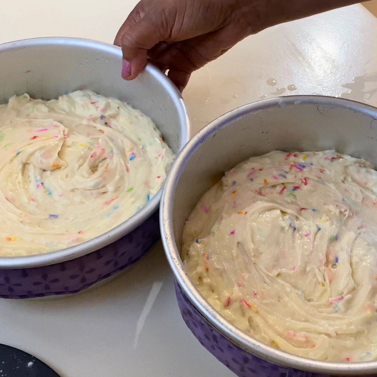 Two baking pan with funfetti cake batter.