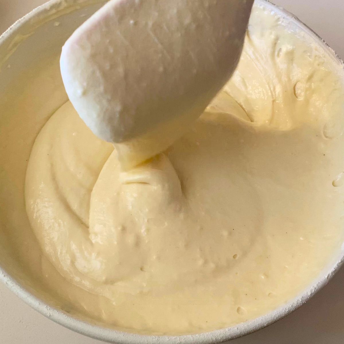 Sour cream cake batter in a white bowl.