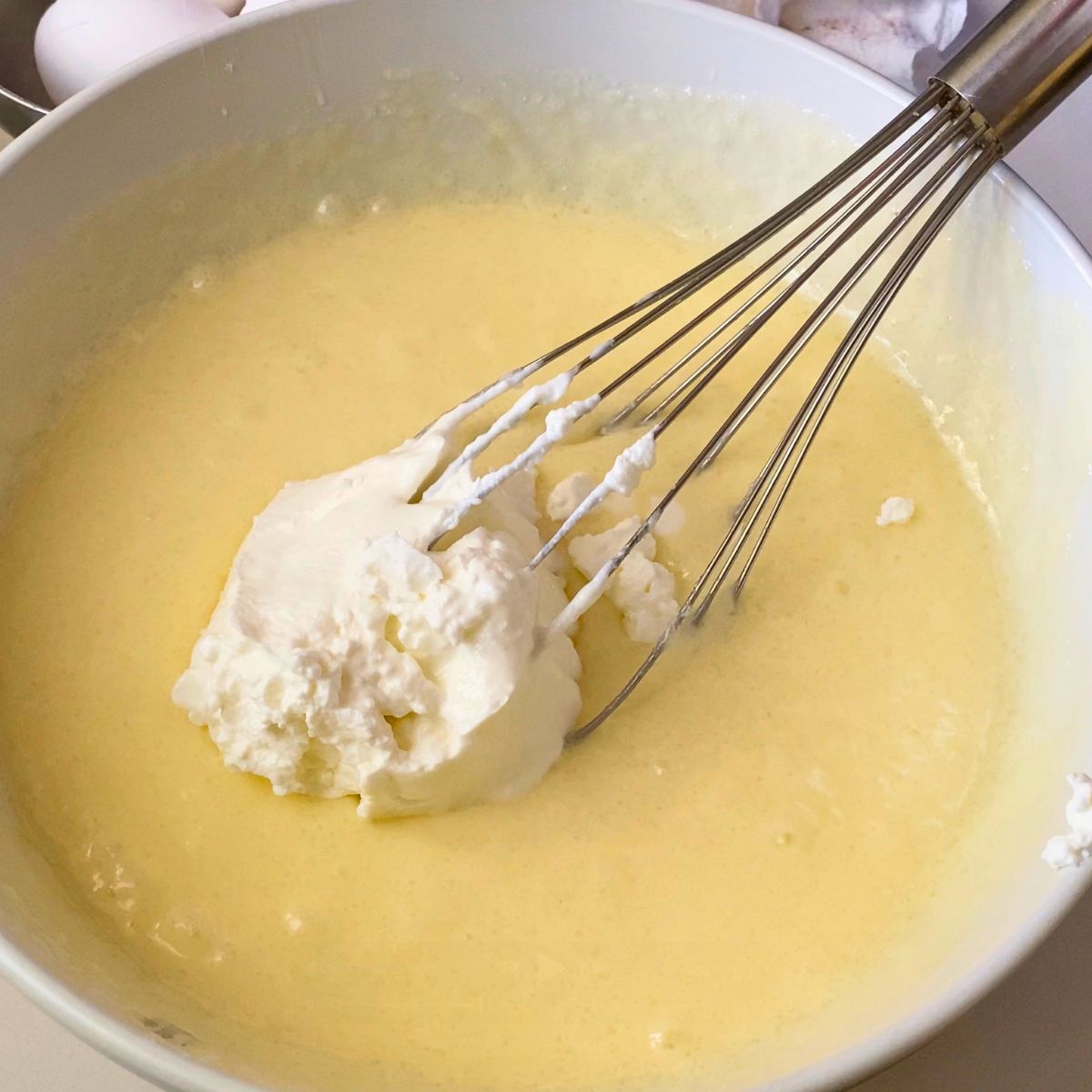 Adding sour cream to the cake batter.