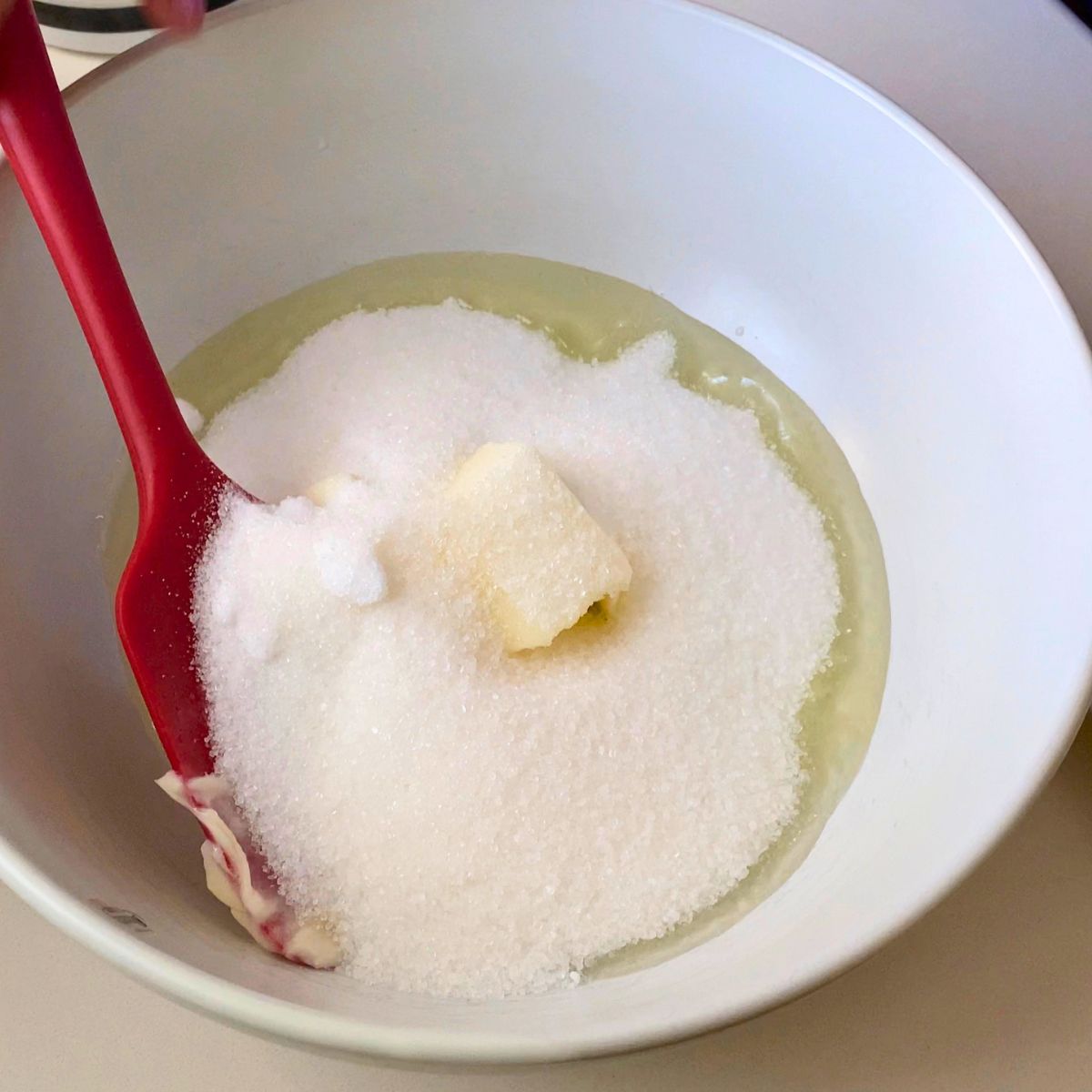 White bowl creaming butter sugar and oil.