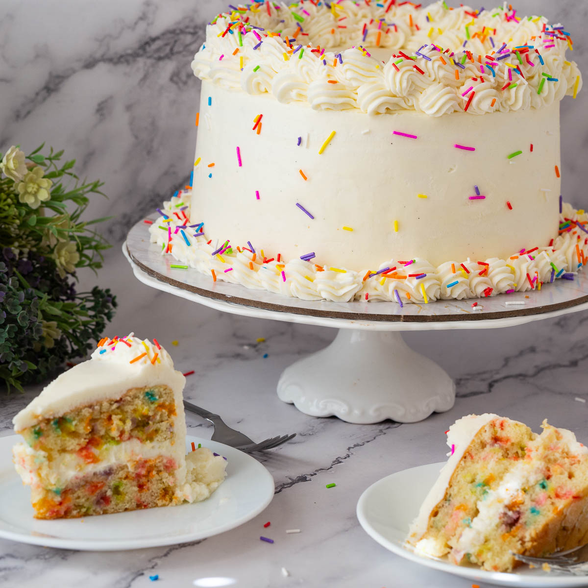 Birthday cake and slices with rainbow funfetti sprinkles.