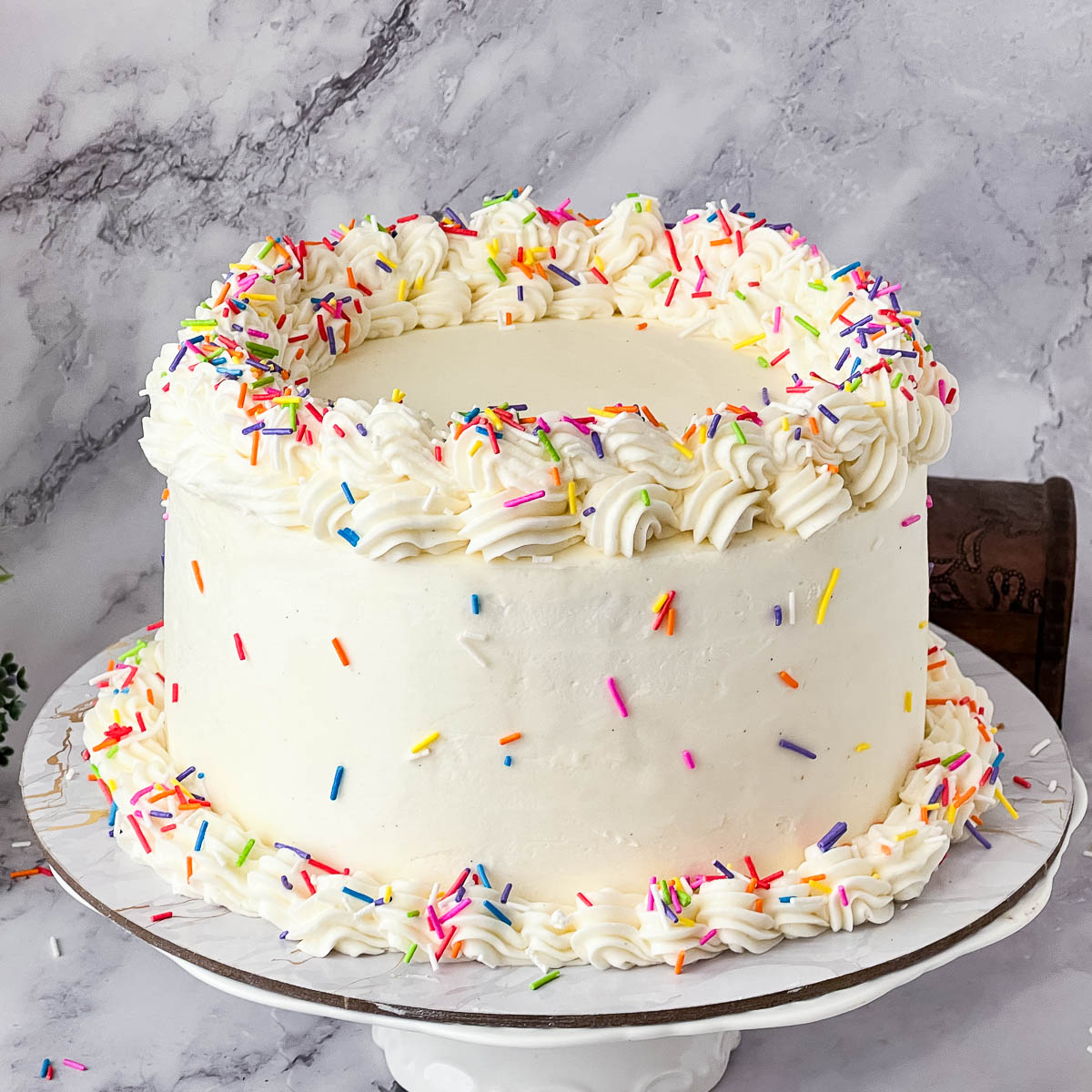 A frosted cake with funfetti.
