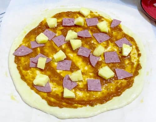 Add the pineapple and ham to the pizza base