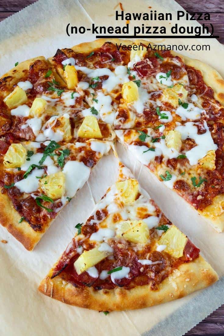 Sliced pineapple pizza on a wooden tray.