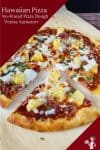 A sliced Hawaiian pizza on a wooden tray.