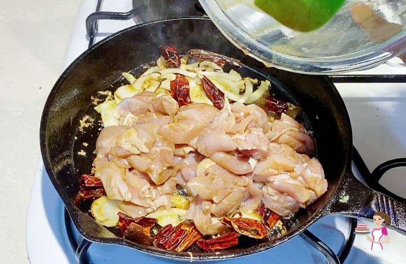 Add the marinated chicken to the kung pao skillet