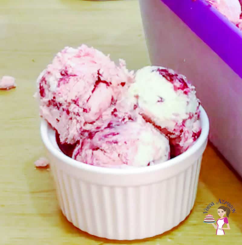 Raspberry ice cream in a small bowl.