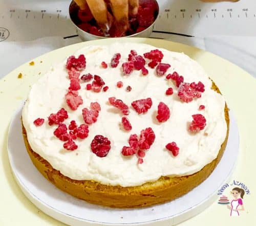 Sprinkle more raspberries over the frosting in between cakes