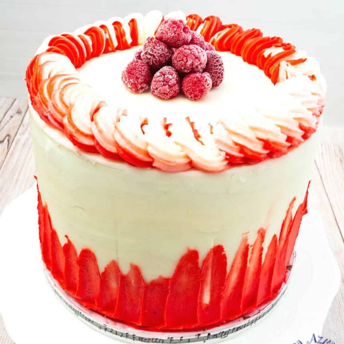 A respberry cake frosted with white chocolate buttercream.