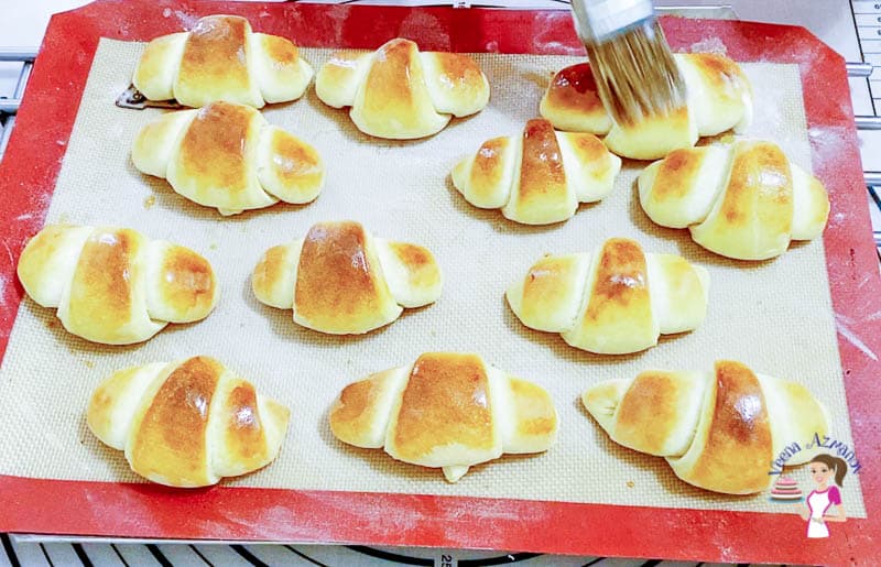 Brush the baked crescents with melted butter