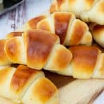 A stack of soft crescent rolls.