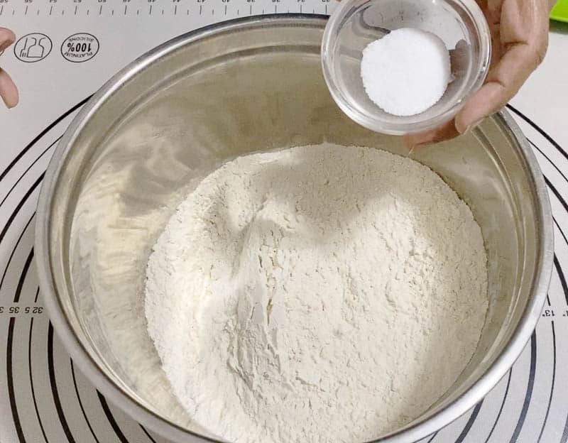 Add salt to the flour for pizza dough