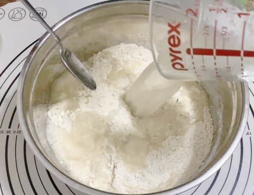 Add the yeast mixture to the flour mixture for pizza dough