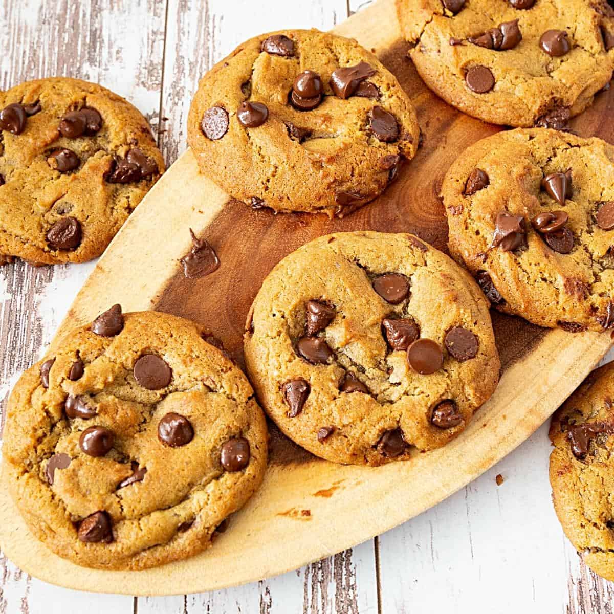 Chocolate chip cookies on a wooden board.