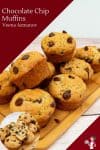 A stack of chocolate chip muffins on a wooden board.
