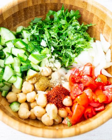 A wooden bowl with chickpeas salad.