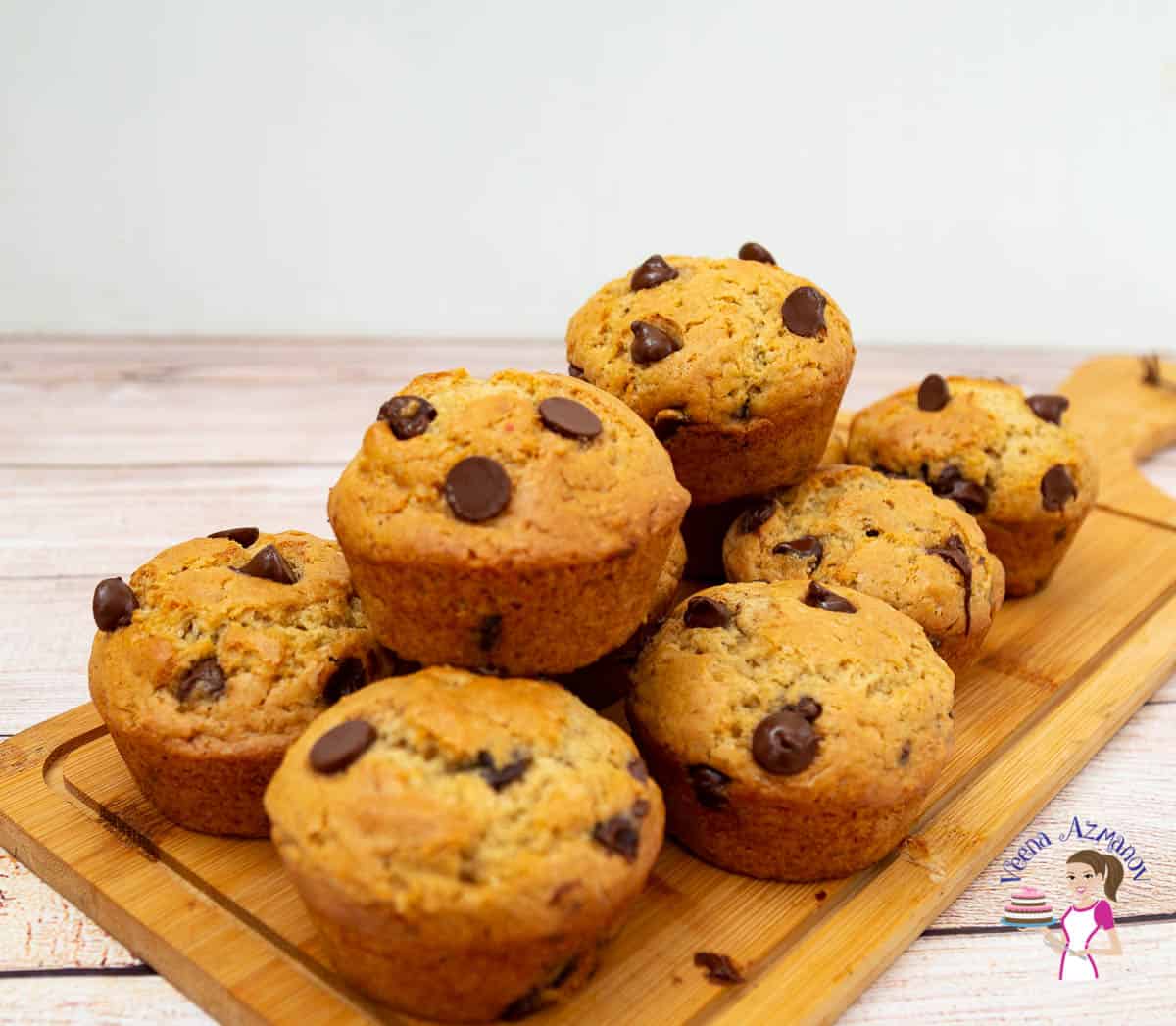 a stack of chocolate chip muffins on a wooden board