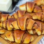 Stack of crescent cinnamon rolls.