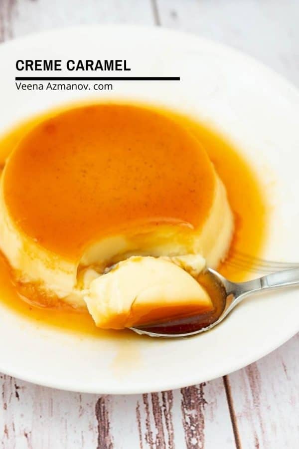 A plate of caramel flan with a spoon.
