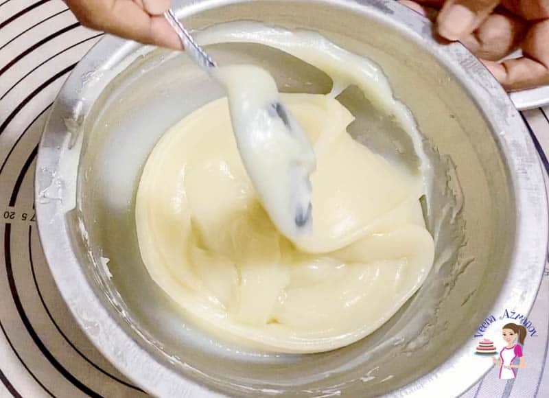 Ermine frosting being mixed in a mixing bowl.