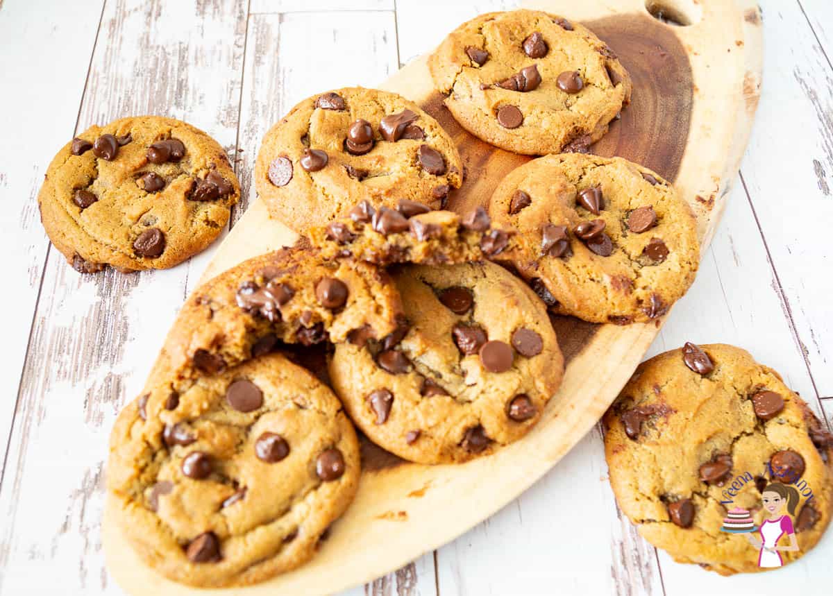 Chocolate chip cookies on a wooden tray.