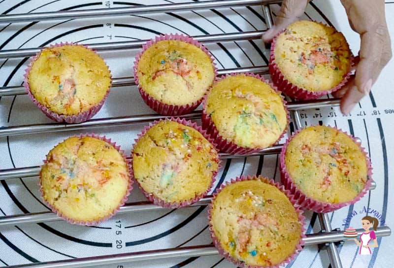 Funfetti cupcakes on a cooling rack.