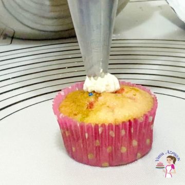Frost the cupcakes with condensed milk frosting and funfetti