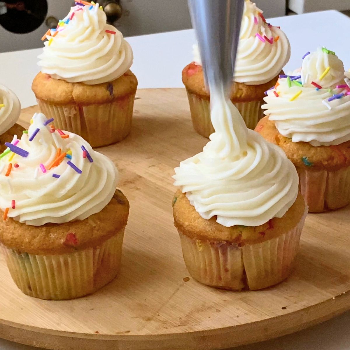 Frosting the funfetti cupcakes.