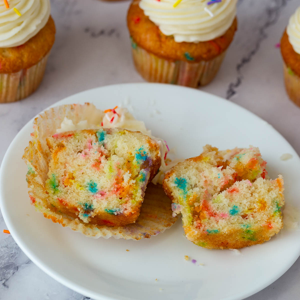 A plate with cupcake cut in half.