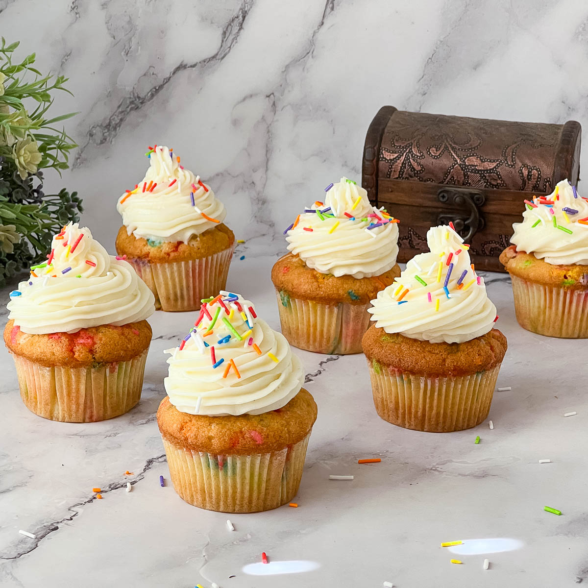 Frosted cupcakes on the table.