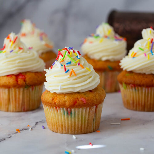 Frosted funfetti cupcakes on the table.
