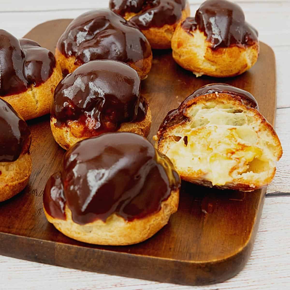 Chocolate glazed profiterole filled with pastry cream.