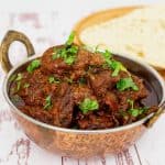 Indian lamb curry in a copper pot.