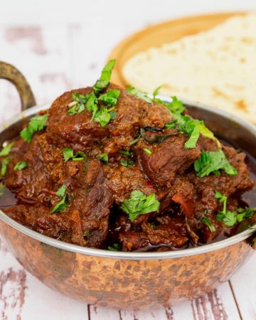 Indian lamb curry in a copper pot.