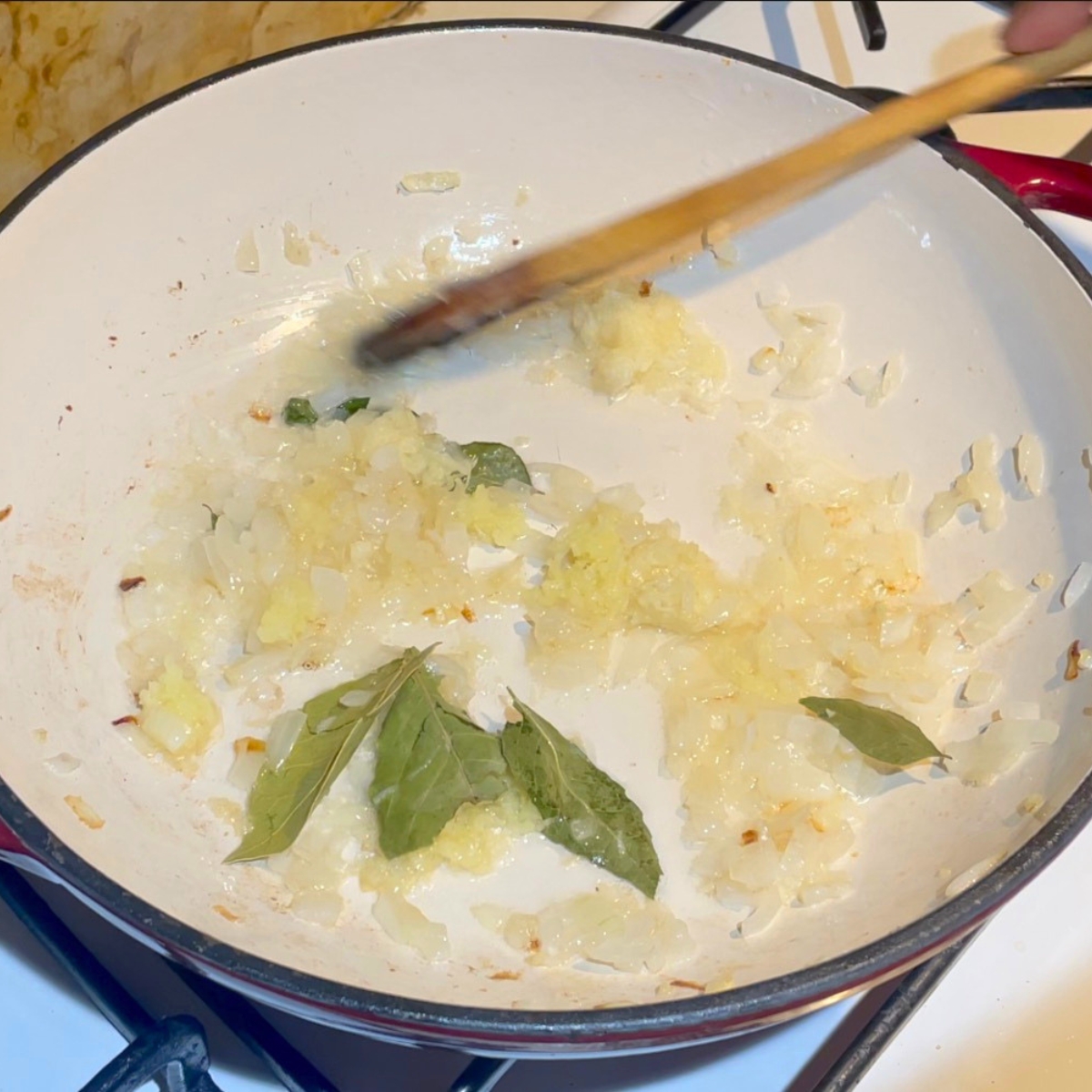 A skillet with sauteeed onions, garlic, ginger.