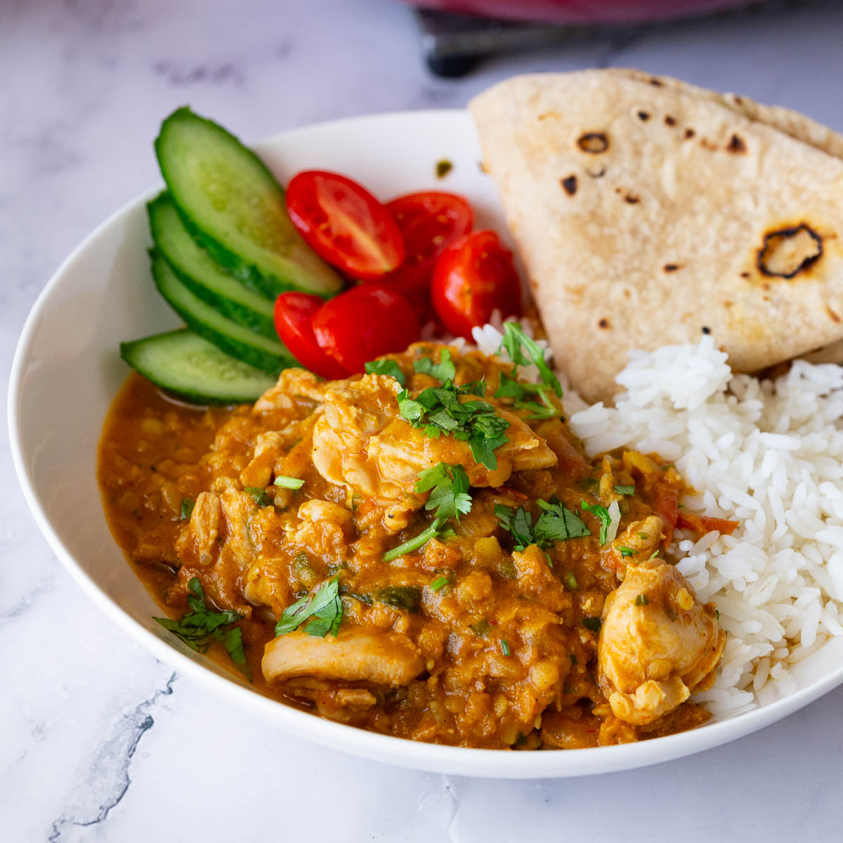 A plate with chicken cooked with lentils.