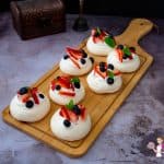 Mini Pavlovas on a wooden board.