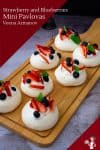 Mini Pavlovas on a wooden board.