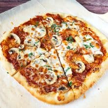 Sliced mushroom pizza on the table.