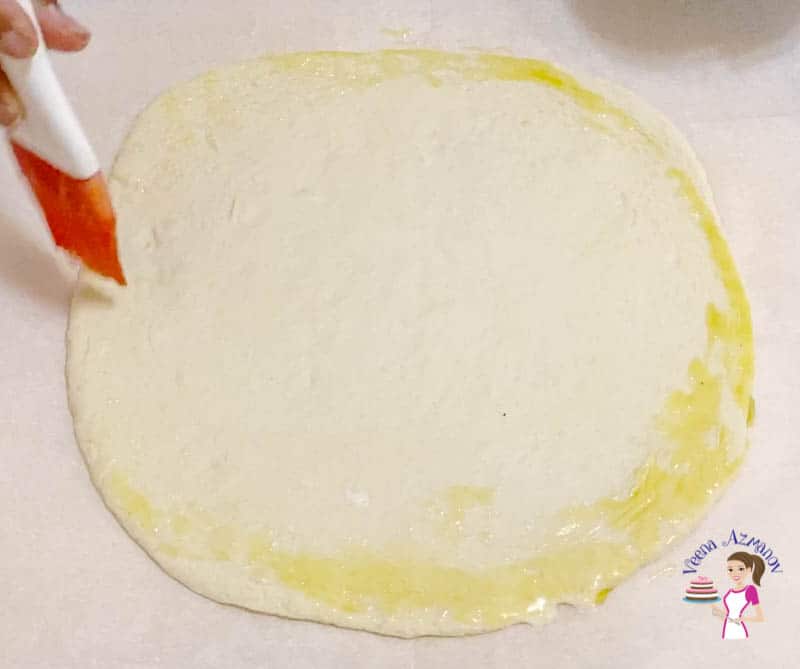 Brush the pizza dough with oil
