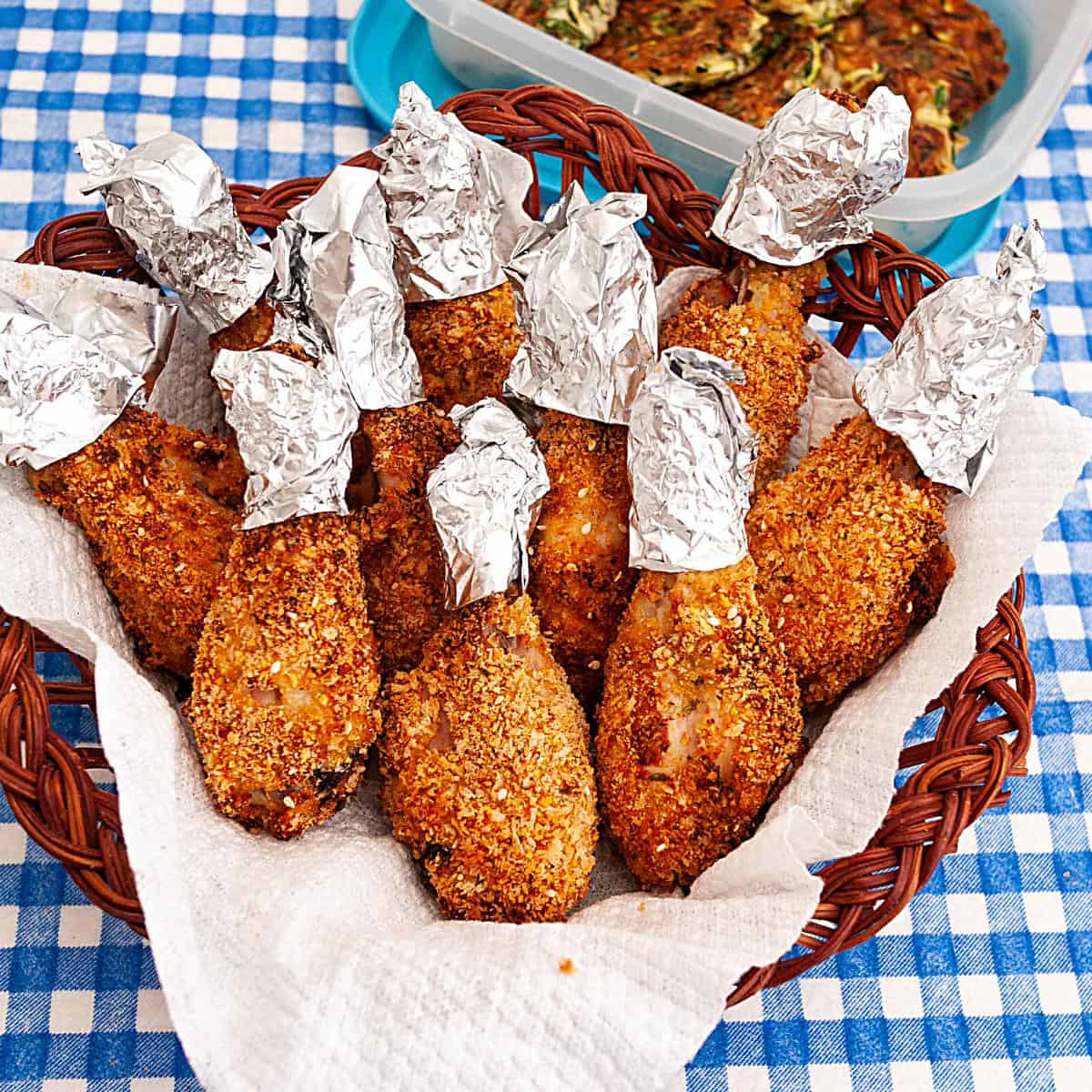 A basket with oven baked chicken legs.