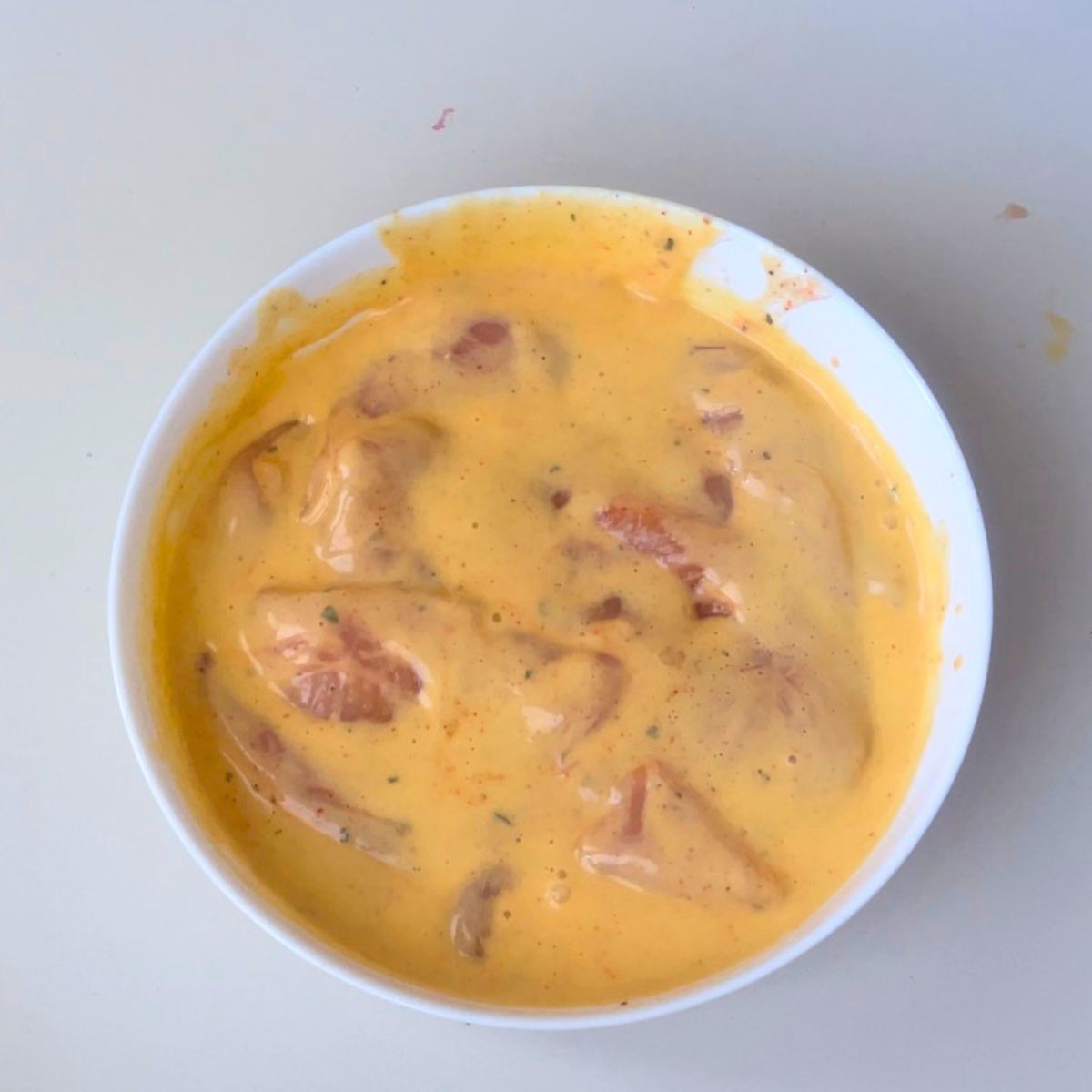Marinating the parmesan chicken breast.