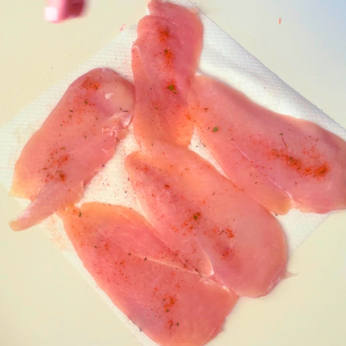 Season the chicken breast cutlets with all purpose seasoning.