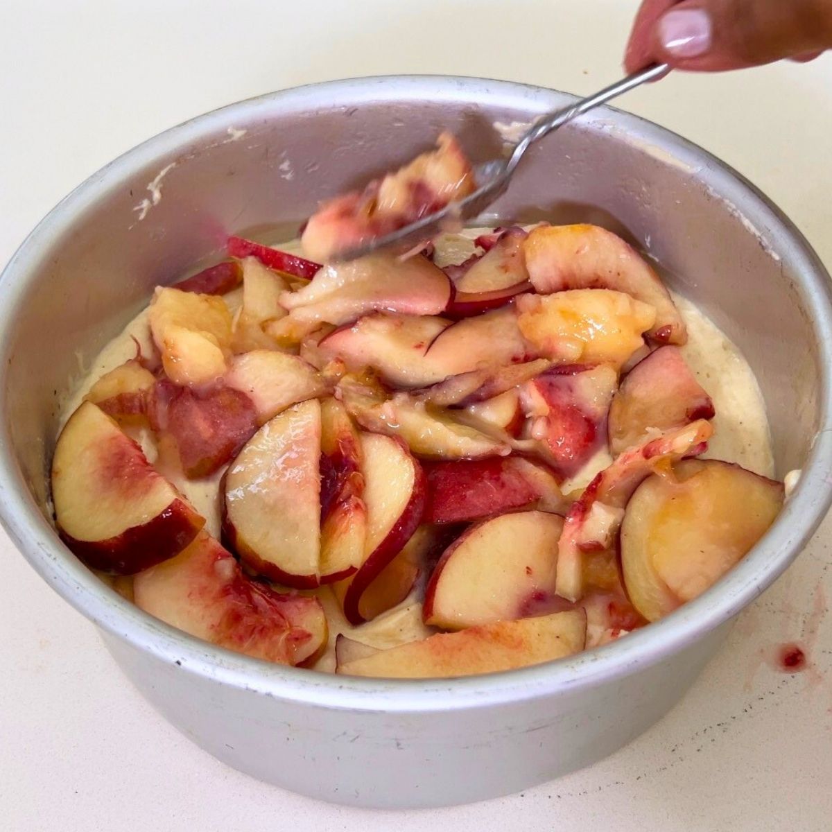 A cake pan with peach layer.