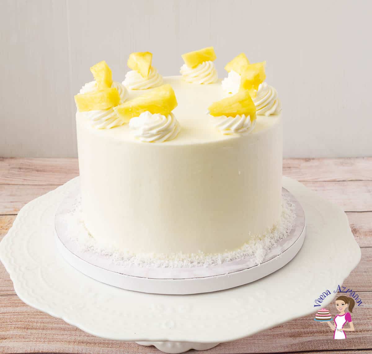 A Pina colada cake on a cake stand.